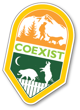 A badge-shaped graphic with COEXIST in bold letters. The top shows a person hiking with a dog by mountains; the bottom depicts a raccoon and a coyote at night near a fence.
