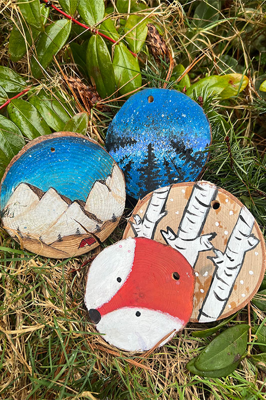 Custom painted wood rounds with leaves in the background