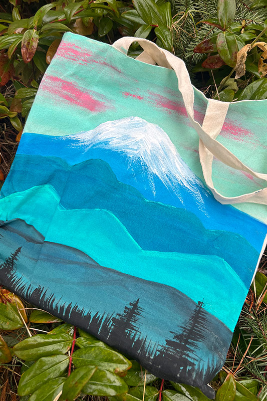 Custom painted tote bag with leaves in the background